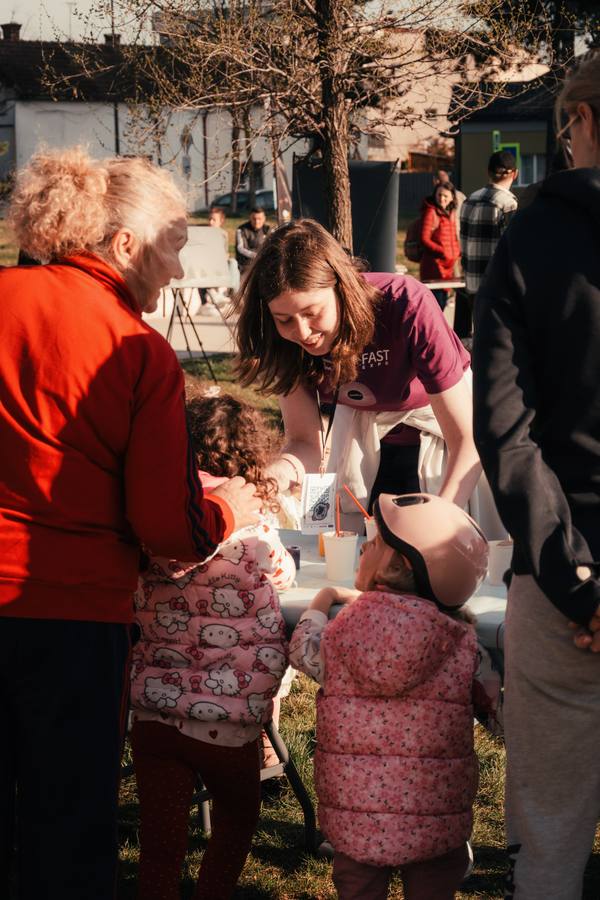 FAST volunteer guiding young children through a hands-on activity
