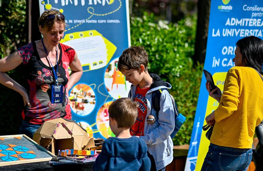 Children and parents at the science club stands