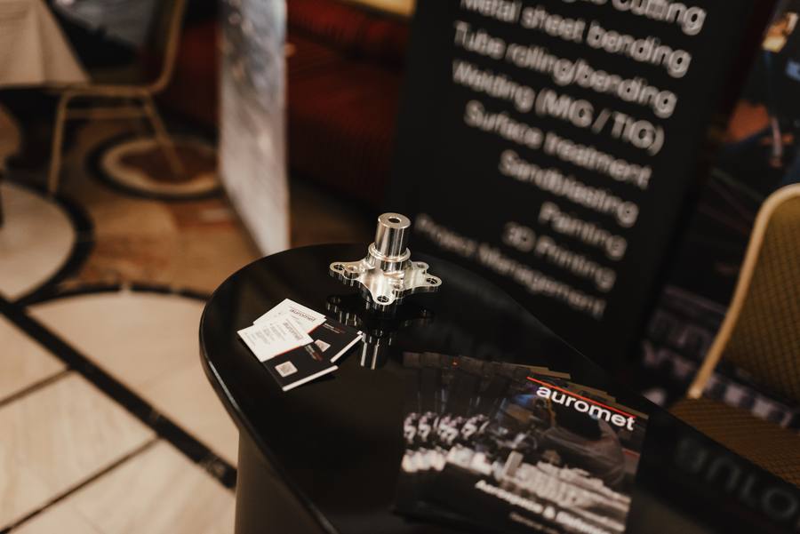 Auromet brochures and a machined part on a partner stand